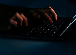 Top 10 AI Tools for Cybersecurity Explained A person on a laptop using ai tools for cybersecurity