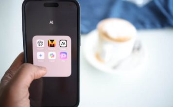 Explore the Pros and Cons of AI in the Workplace Someone using a phone in the workplace an AI apps, debating the pros and cons of ai in the workplace